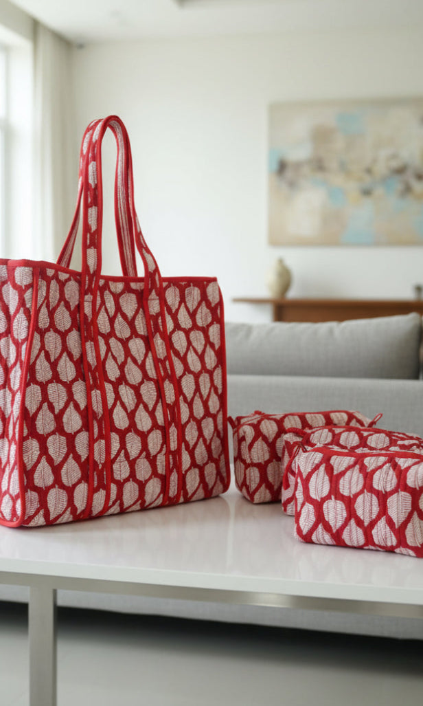 Red and white patterned bag on a floral-patterned surface