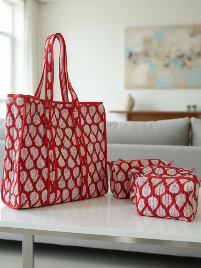 Red and white patterned bag on a floral-patterned surface