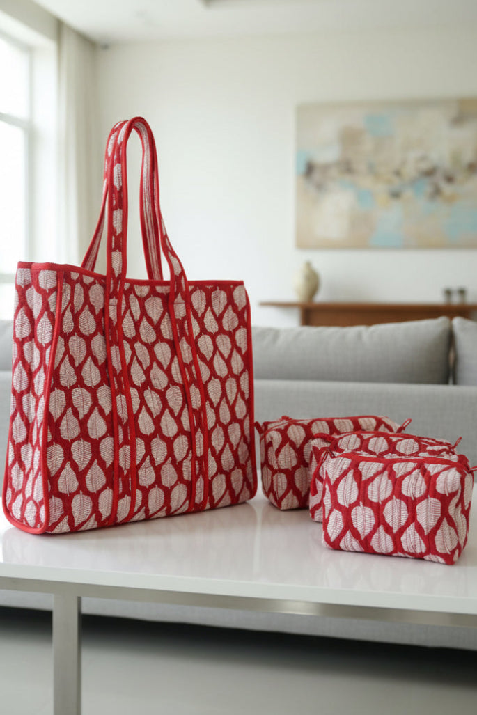 Red and white patterned bag on a floral-patterned surface