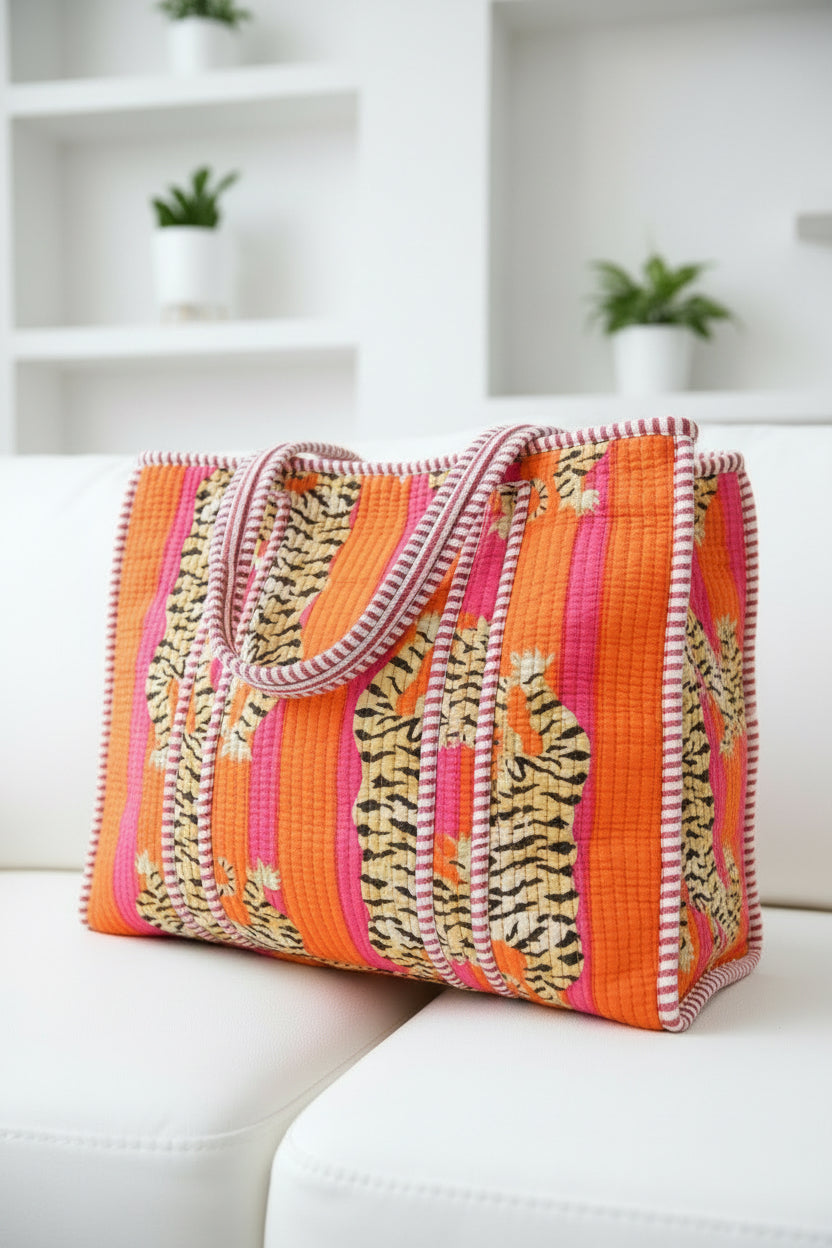 Colorful striped pink mini tote bag on a white couch