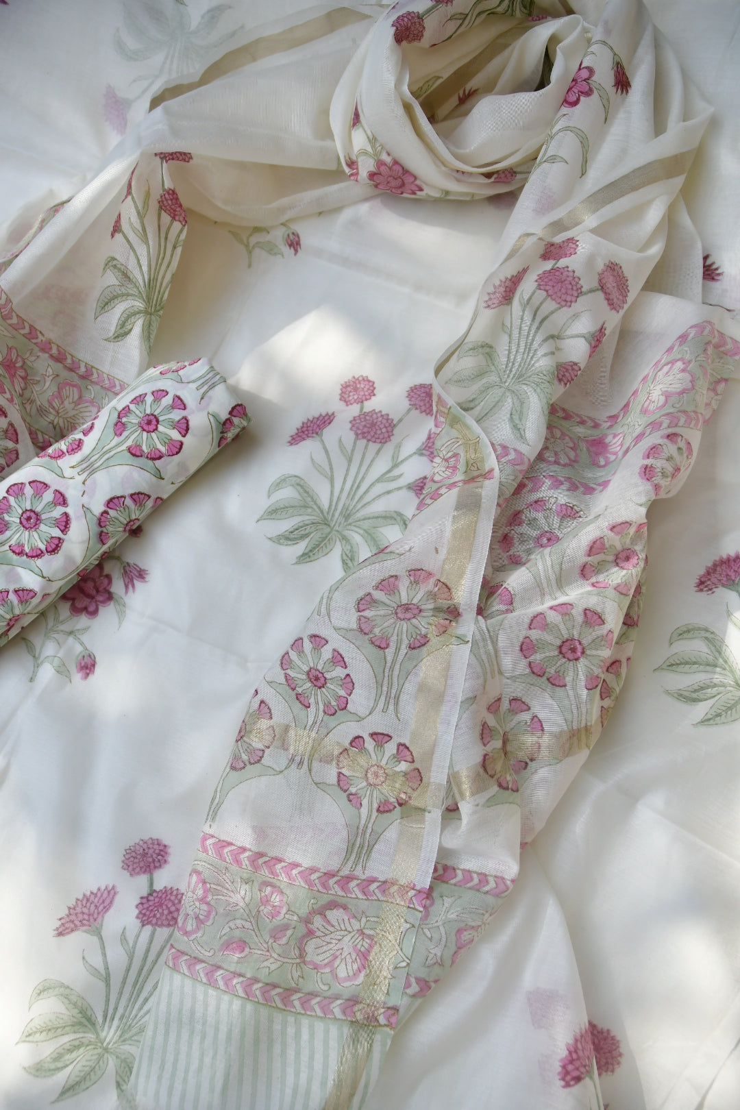 Floral patterned fabric with pink and green flowers on a white background
