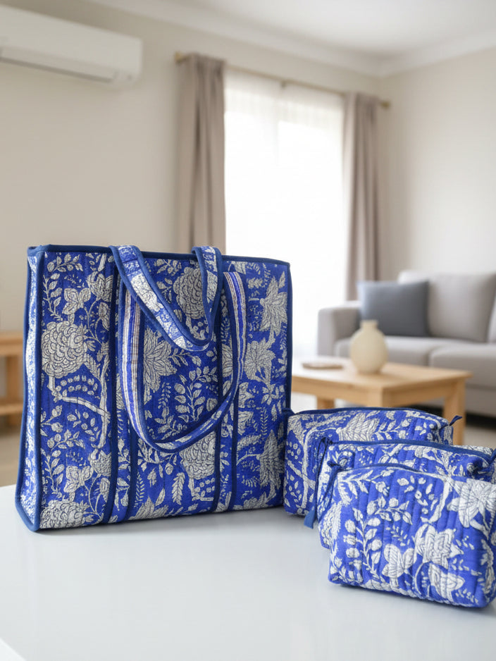 Blue and white patterned bags on a wooden surface next to a television.