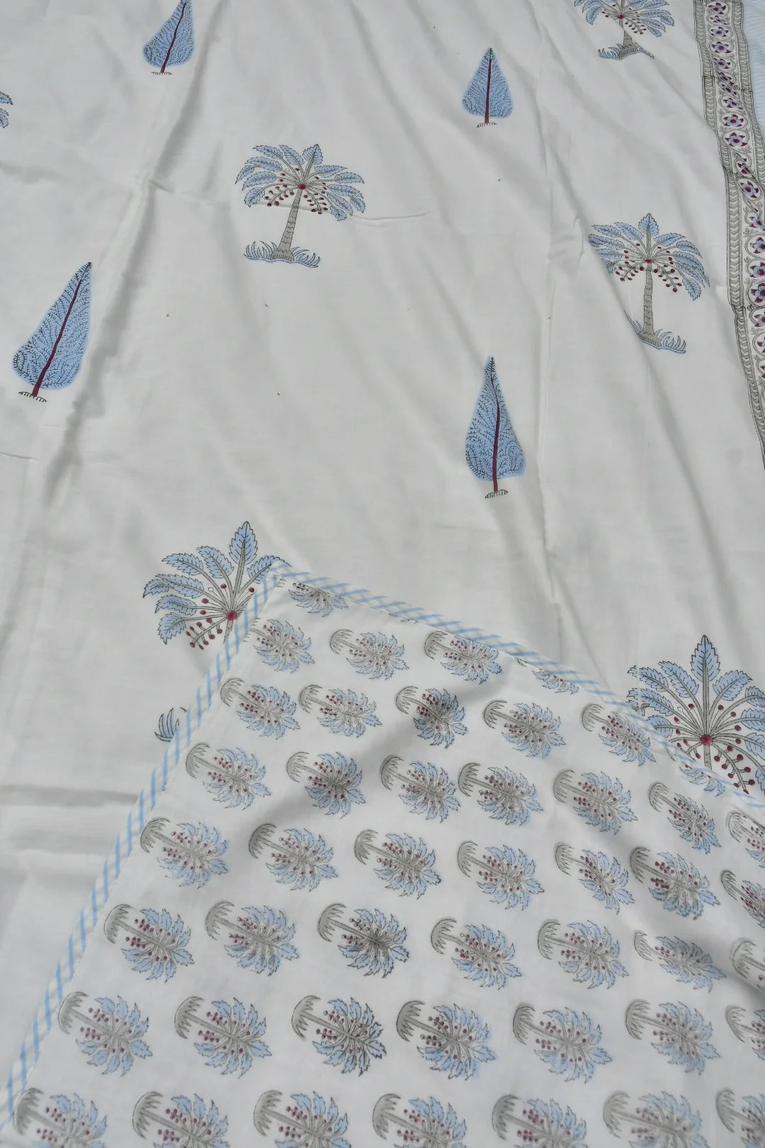Textile with floral and tree patterns on a white background