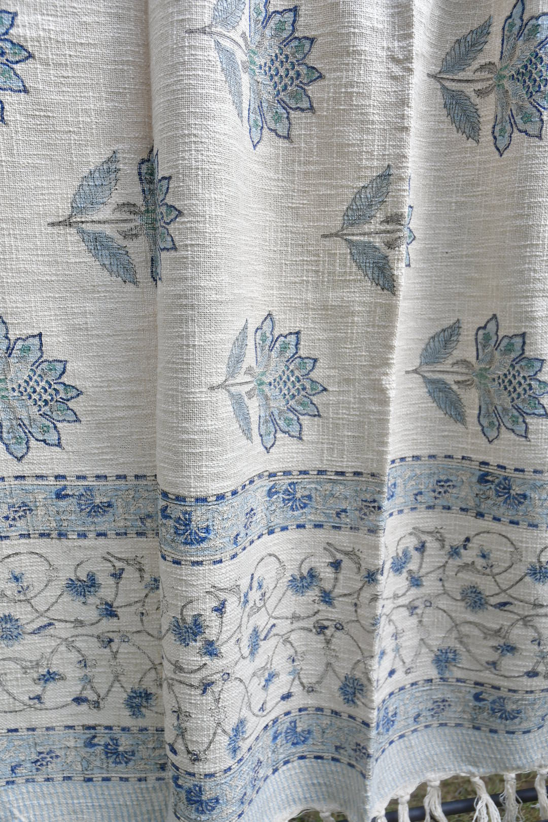 Textile fabric with blue floral patterns on a white background