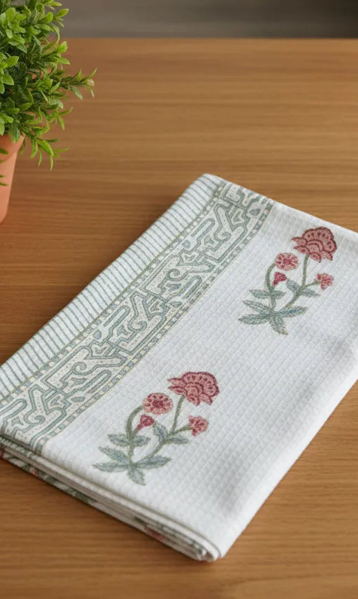 Folded fabric with floral patterns on a wooden surface