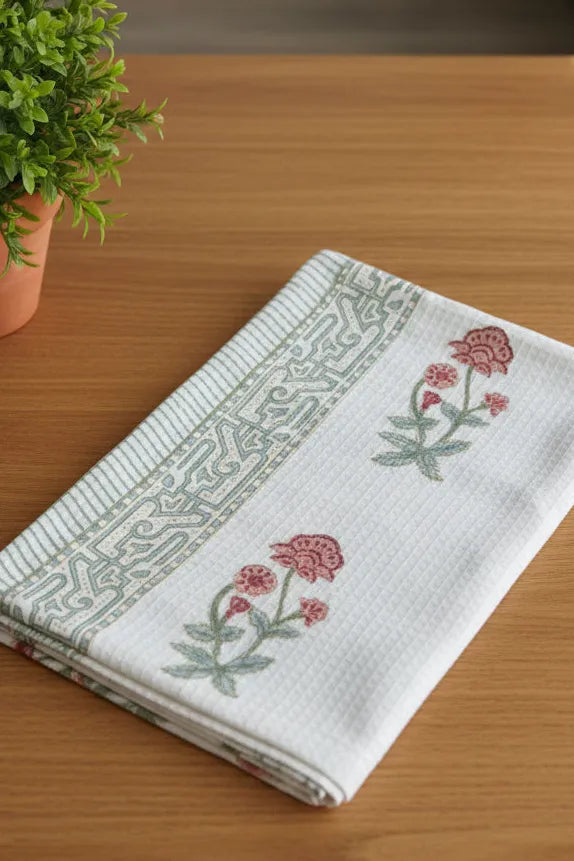 Folded fabric with floral patterns on a wooden surface