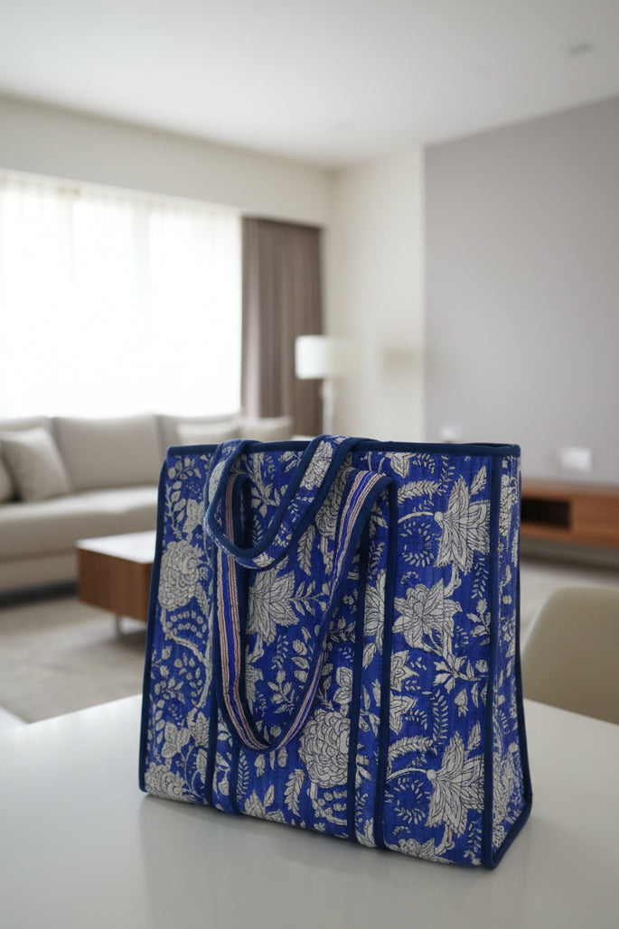 Blue floral-patterned bag on a table in a living room setting