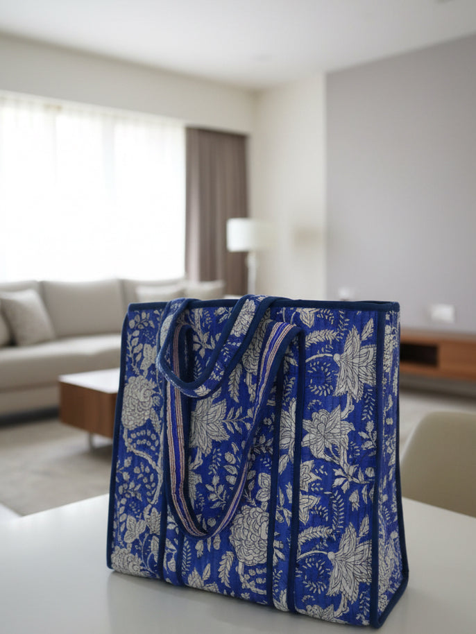 Blue floral-patterned bag on a table in a living room setting
