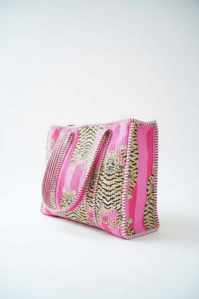 Pink and gold patterned clutch bag on a white background