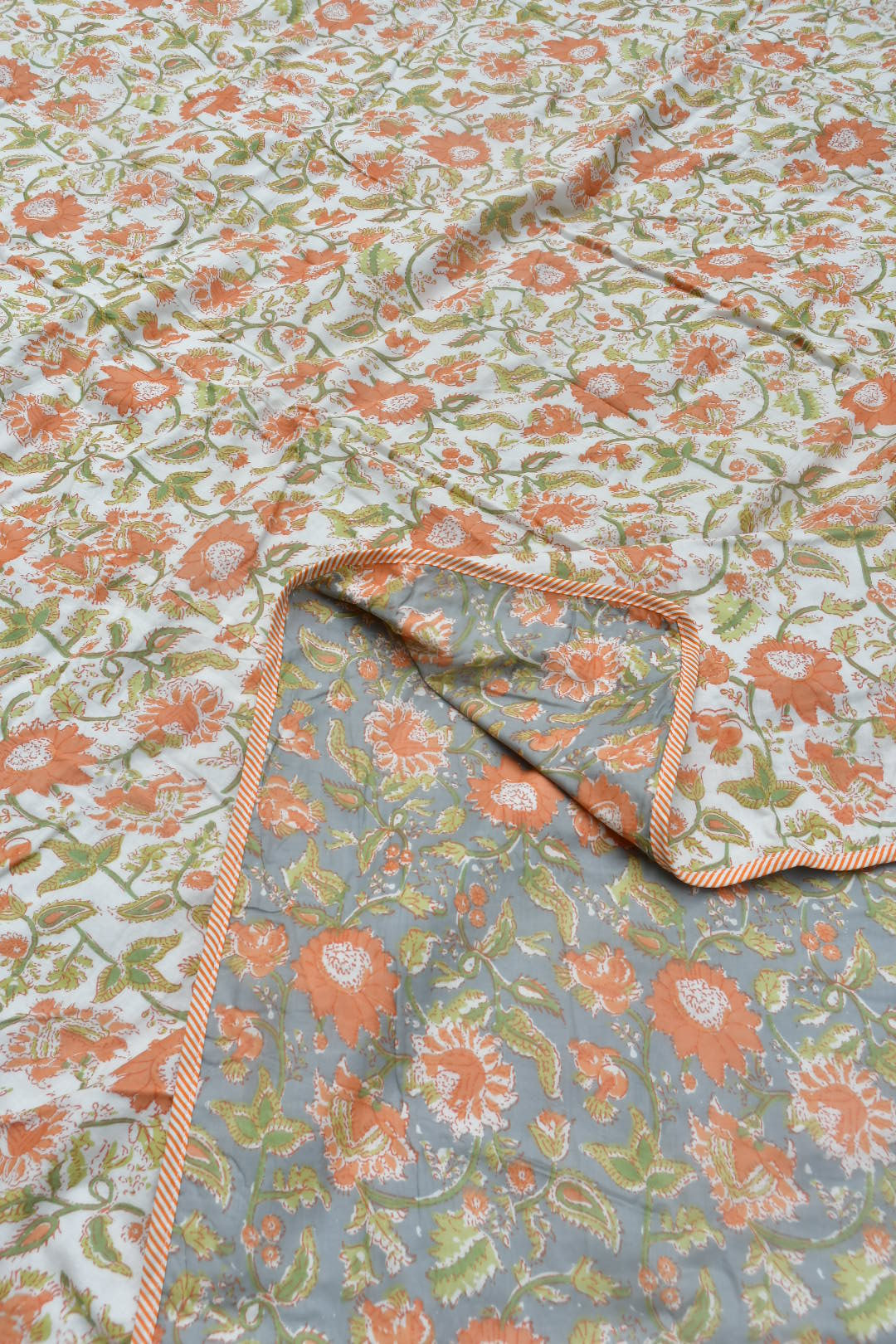 Floral patterned fabric with a visible seam on a textured background