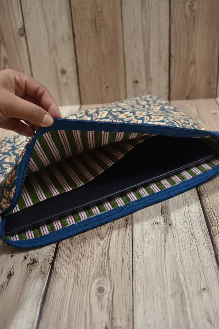 Floral fabric with a blue border held open on a wooden surface