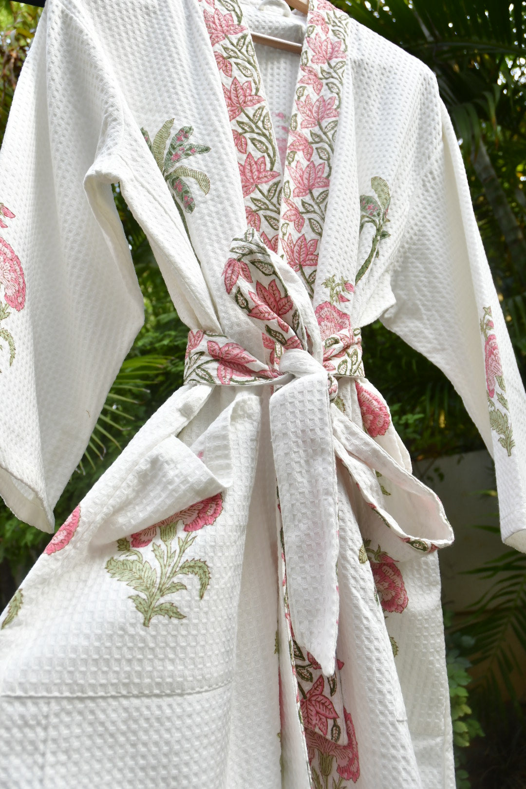 White paper towels with floral pattern on a green leafy background