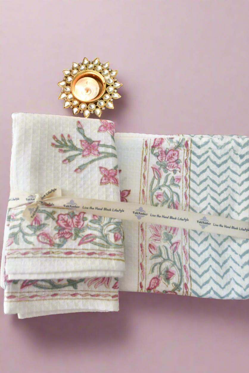 Set of patterned napkins with a decorative candle on a pink background