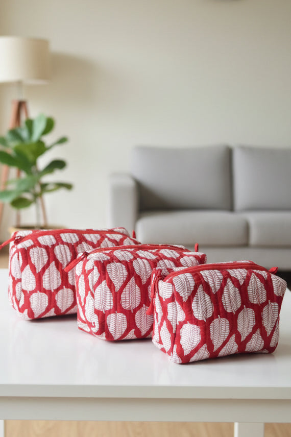 Red and white patterned bag on a white surface with a blurred background