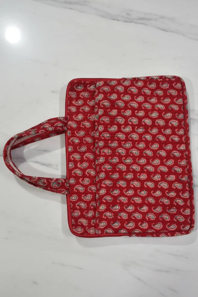 Red patterned bag on a white marble surface
