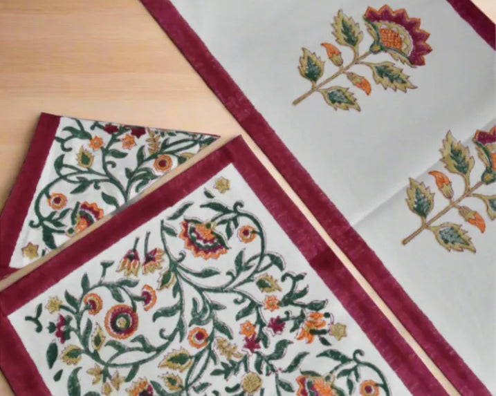Decorative table runner with floral patterns on a wooden surface
