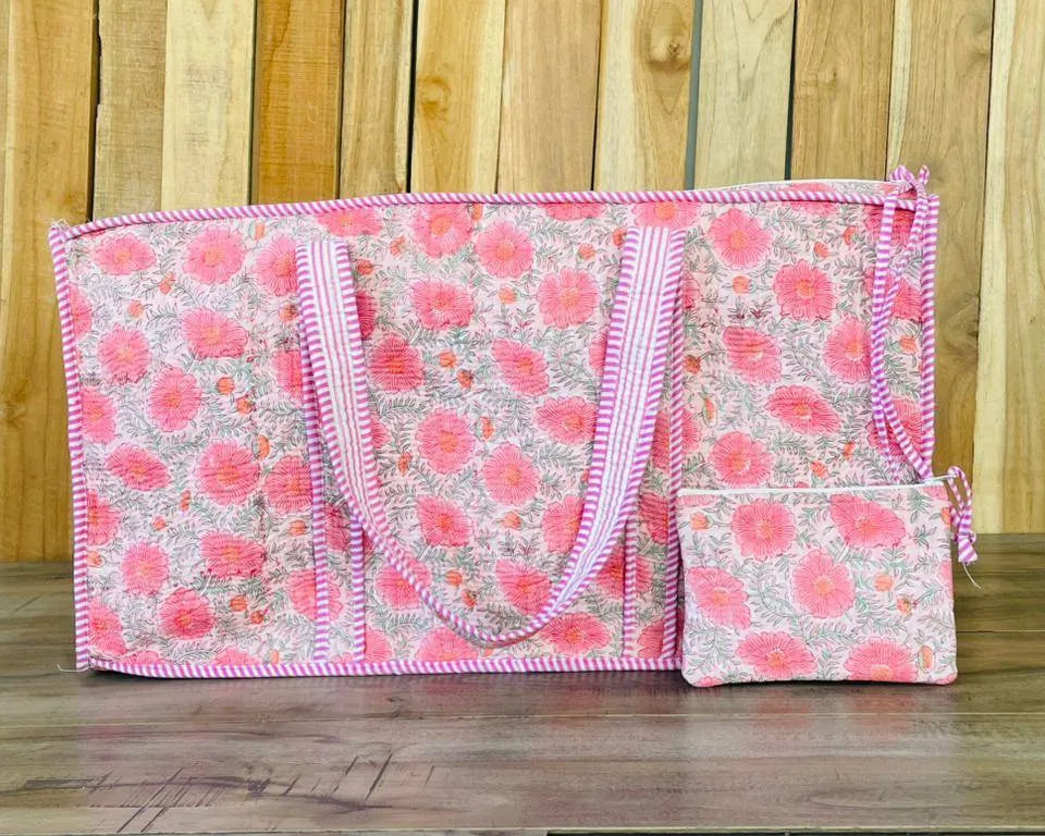 Floral patterned bag with pink trim on a wooden surface