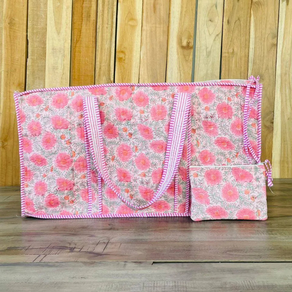 Floral patterned bag with pink trim on a wooden surface