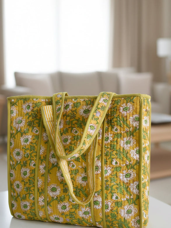 Yellow floral-patterned bag with a strap on a plain background