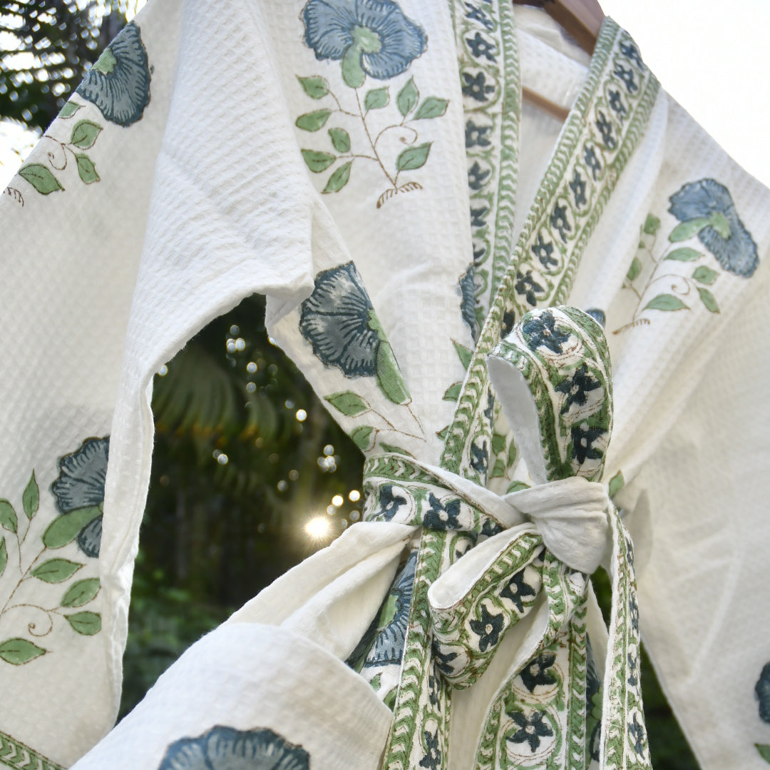 Close-up of a floral-patterned fabric with green and blue designs.