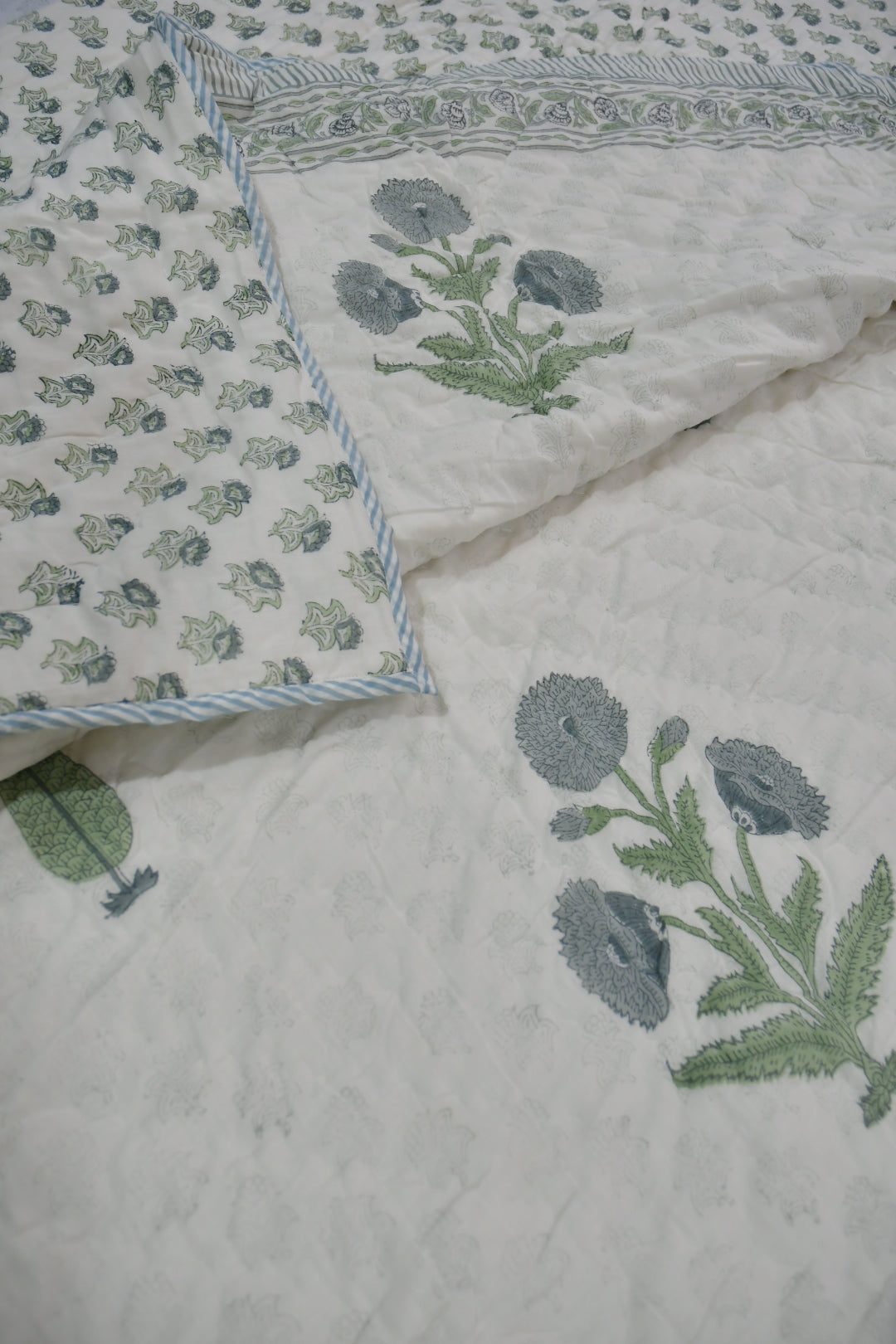 Floral patterned fabric with green leaves on a light background