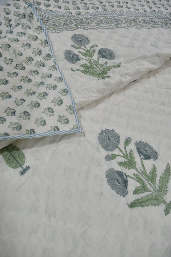 Floral patterned fabric with green leaves on a light background