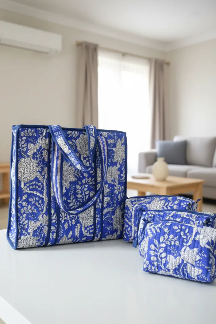 Blue and white patterned tote bag and pouch on a white surface with a neutral background