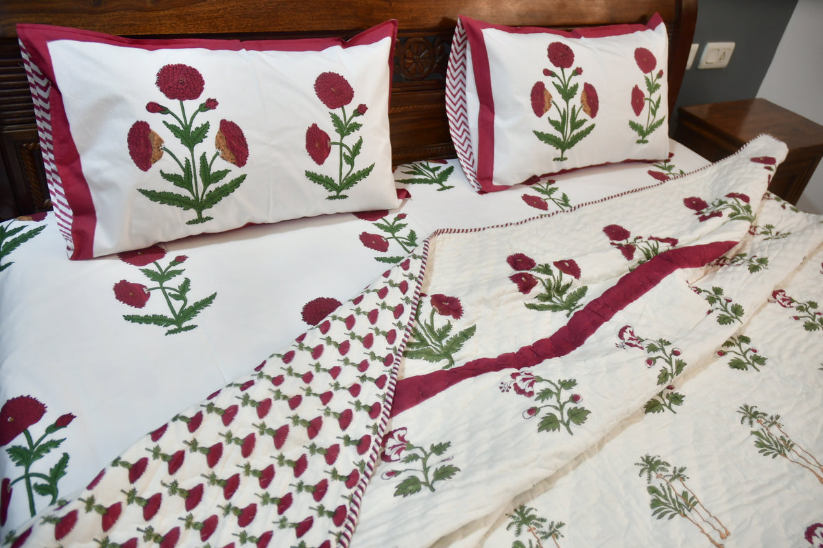 Floral patterned bedspread and pillows on a bed