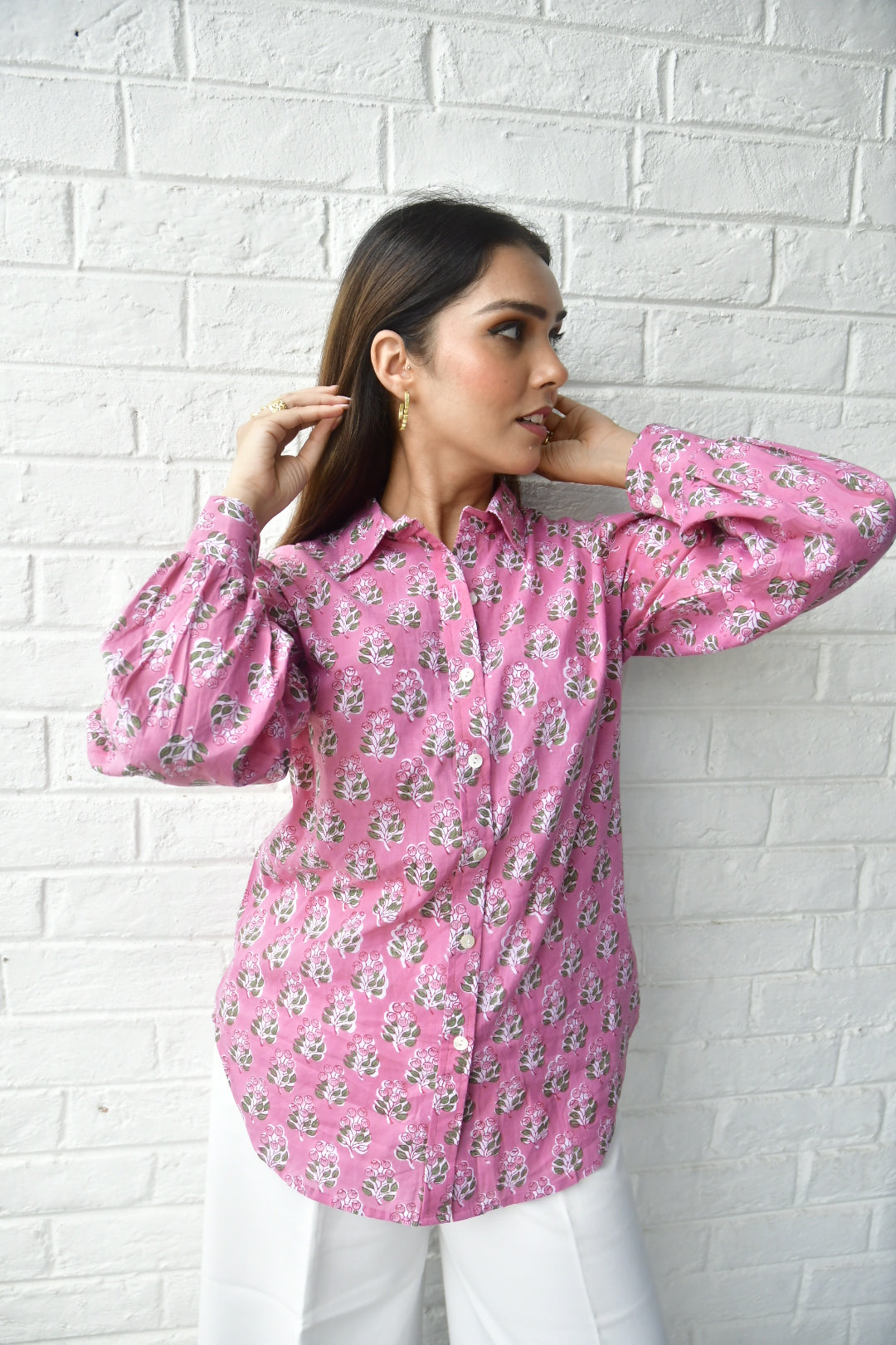 Woman wearing a pink floral dress on a light gray tiled floor
