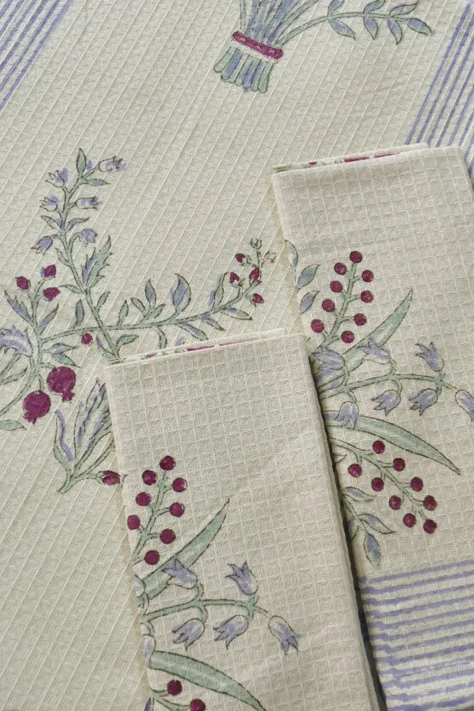 Set of kitchen towels with floral embroidery on a textured fabric background