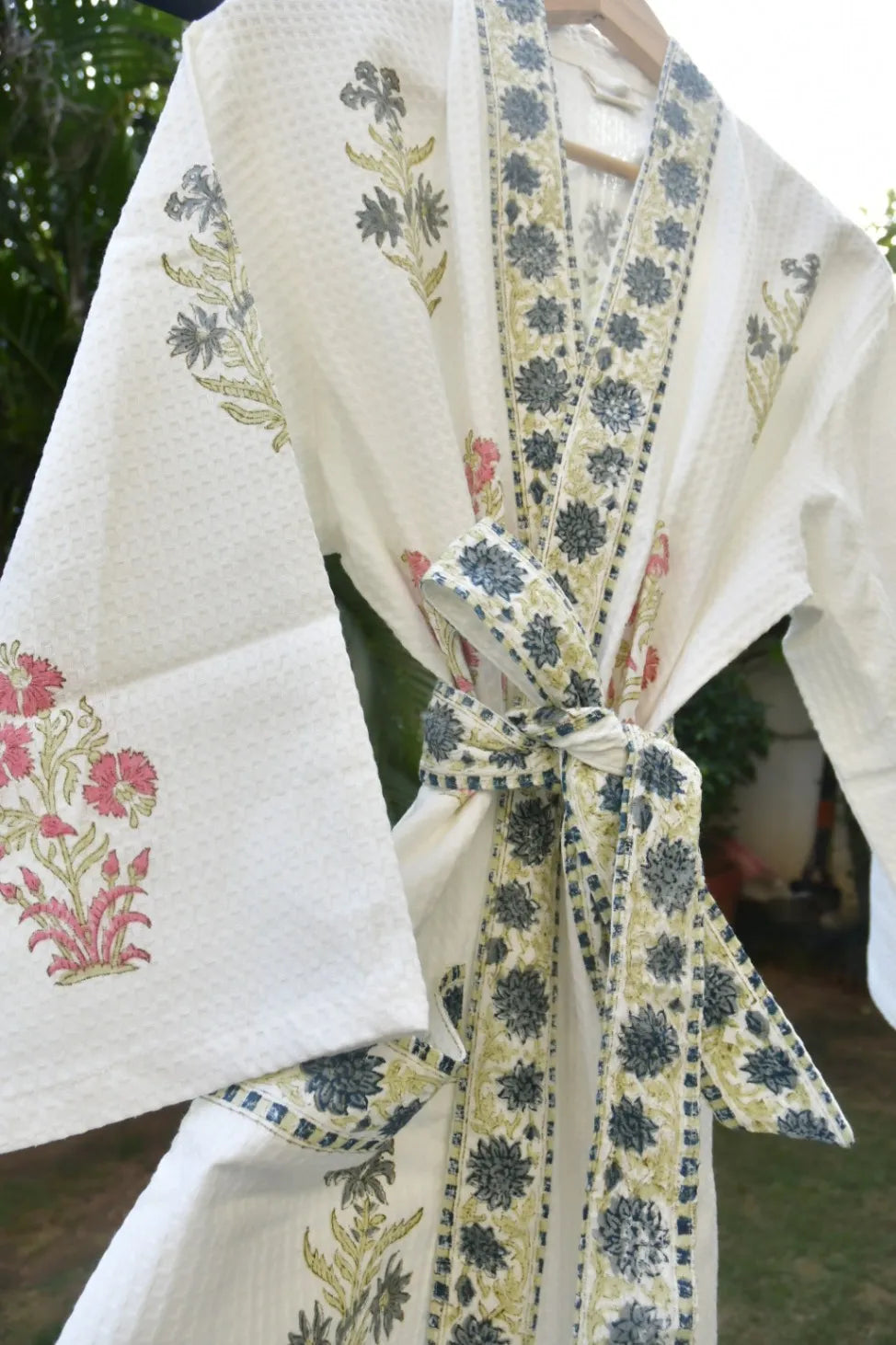 White fabric with floral patterns and a tied bow, possibly a kimono or traditional garment.