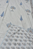 Textile with floral and tree patterns on a white background