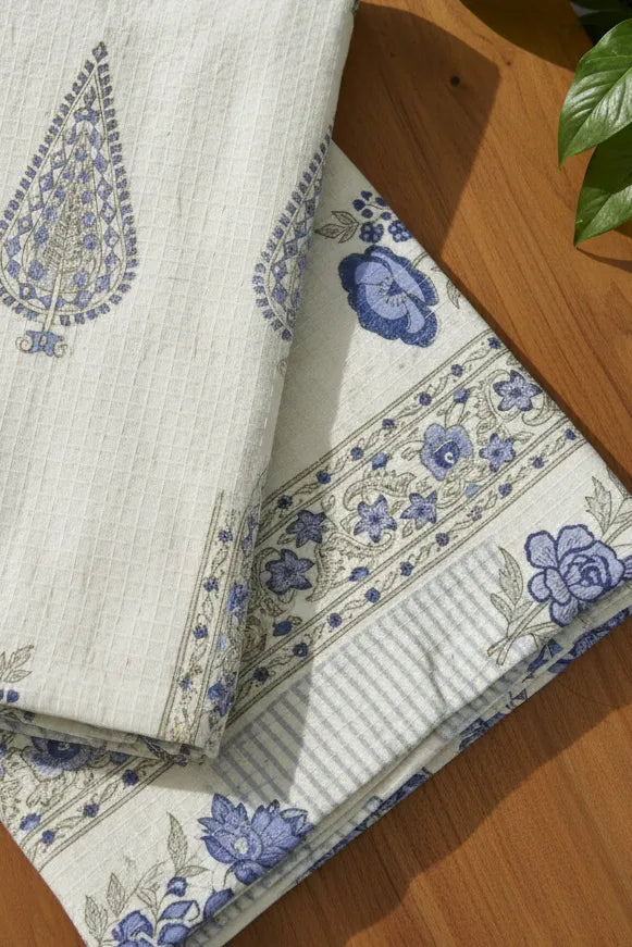 Folded fabric with blue floral patterns on a wooden surface