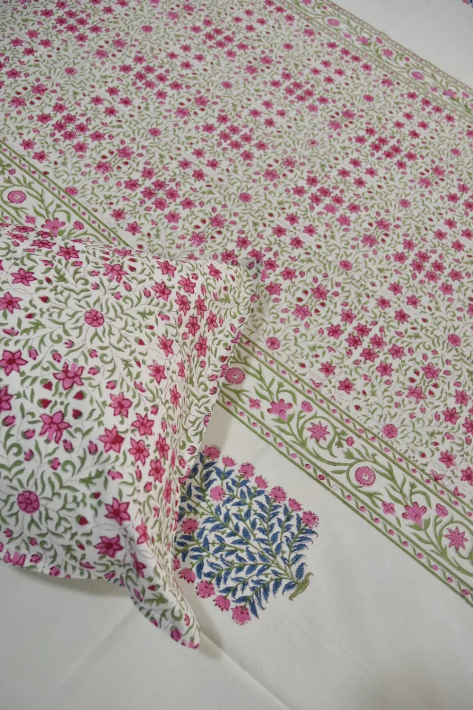 Jaipuri Bedsheet with pink flowers on a white background