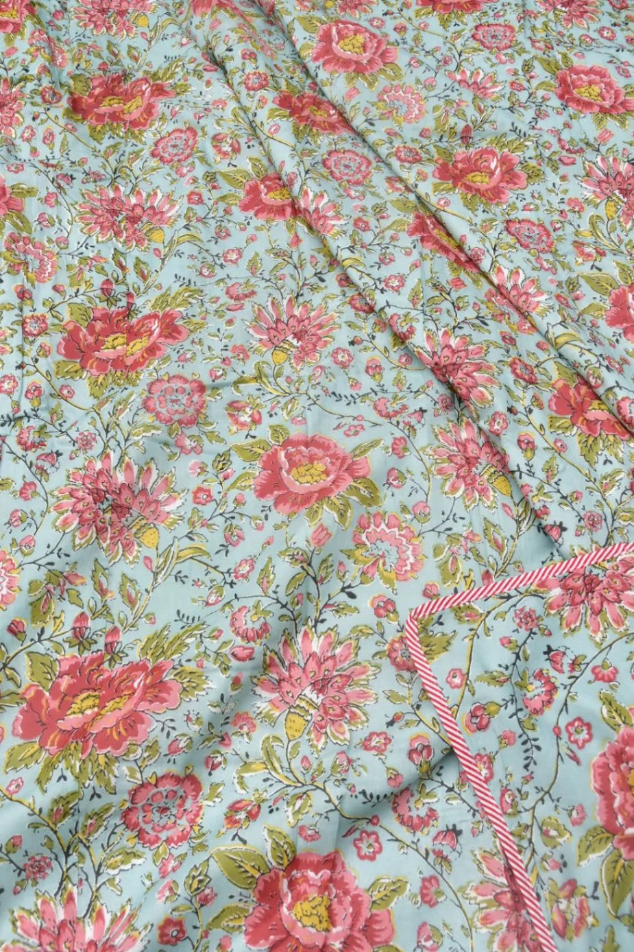 Floral fabric with pink flowers on a light blue background
