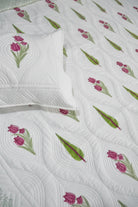 Floral Bedcover with pink tulips and green leaves on a white background