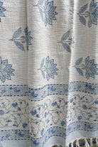 Textile fabric with blue floral patterns on a white background
