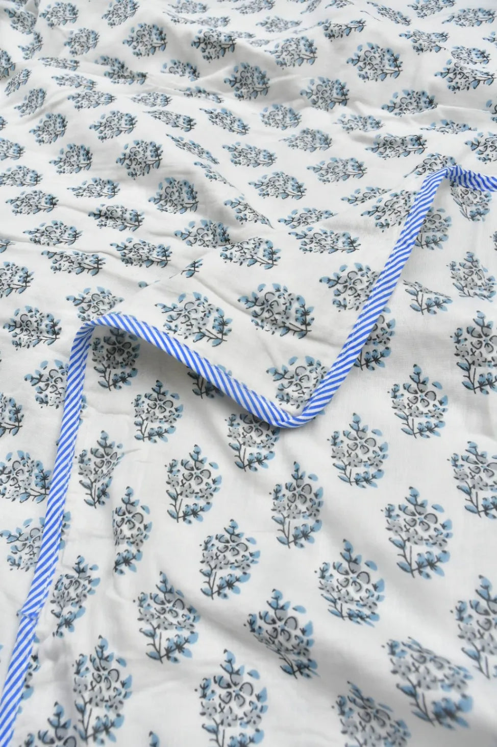 Floral patterned Dohar with a blue and white striped trim