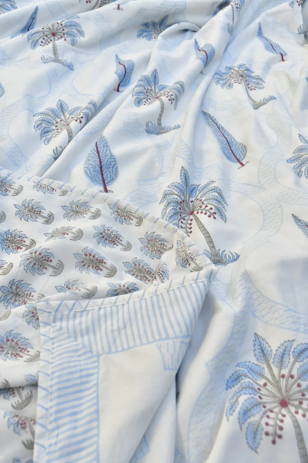 Close-up of embroidered fabric with floral patterns on a white background