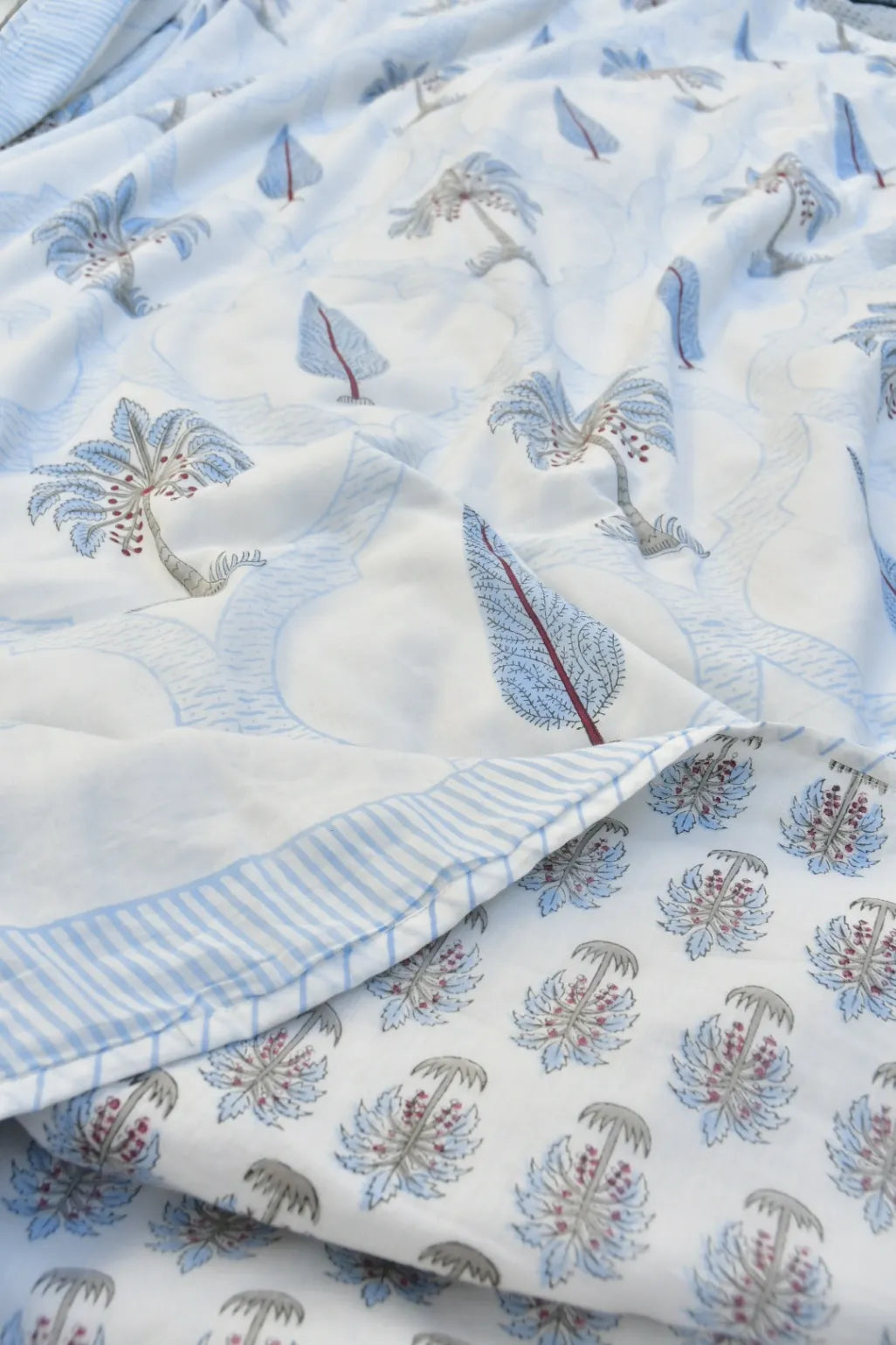 Floral and leaf patterned fabric with blue and white colors