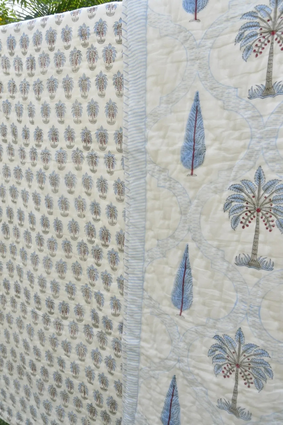 Quilt with palm tree pattern on a white background