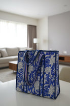 Blue floral-patterned bag on a table in a living room setting
