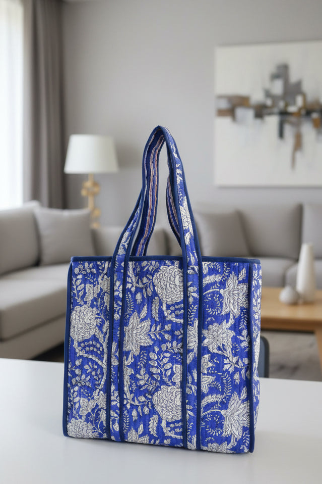 Blue and white floral patterned bag with a plain background