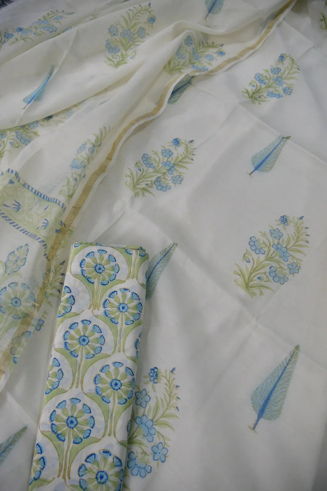 White fabric with blue and green floral patterns