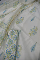 White fabric with blue and green floral patterns