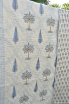 Quilt with tree pattern draped over a surface
