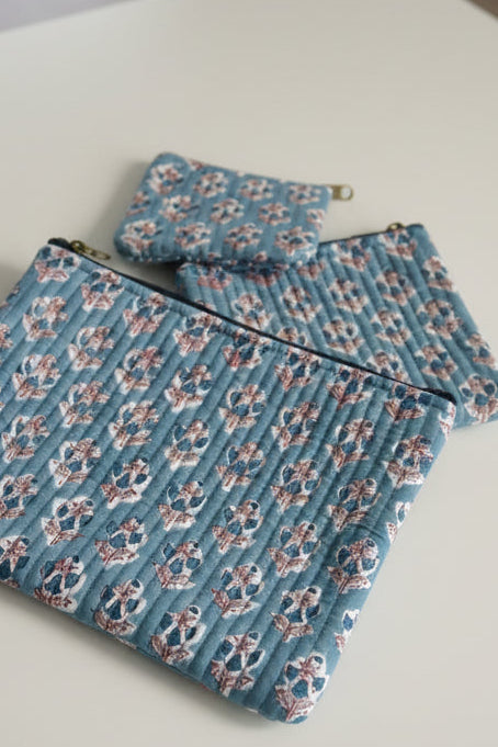 Floral-patterned fabric on a textured surface with floral designs.