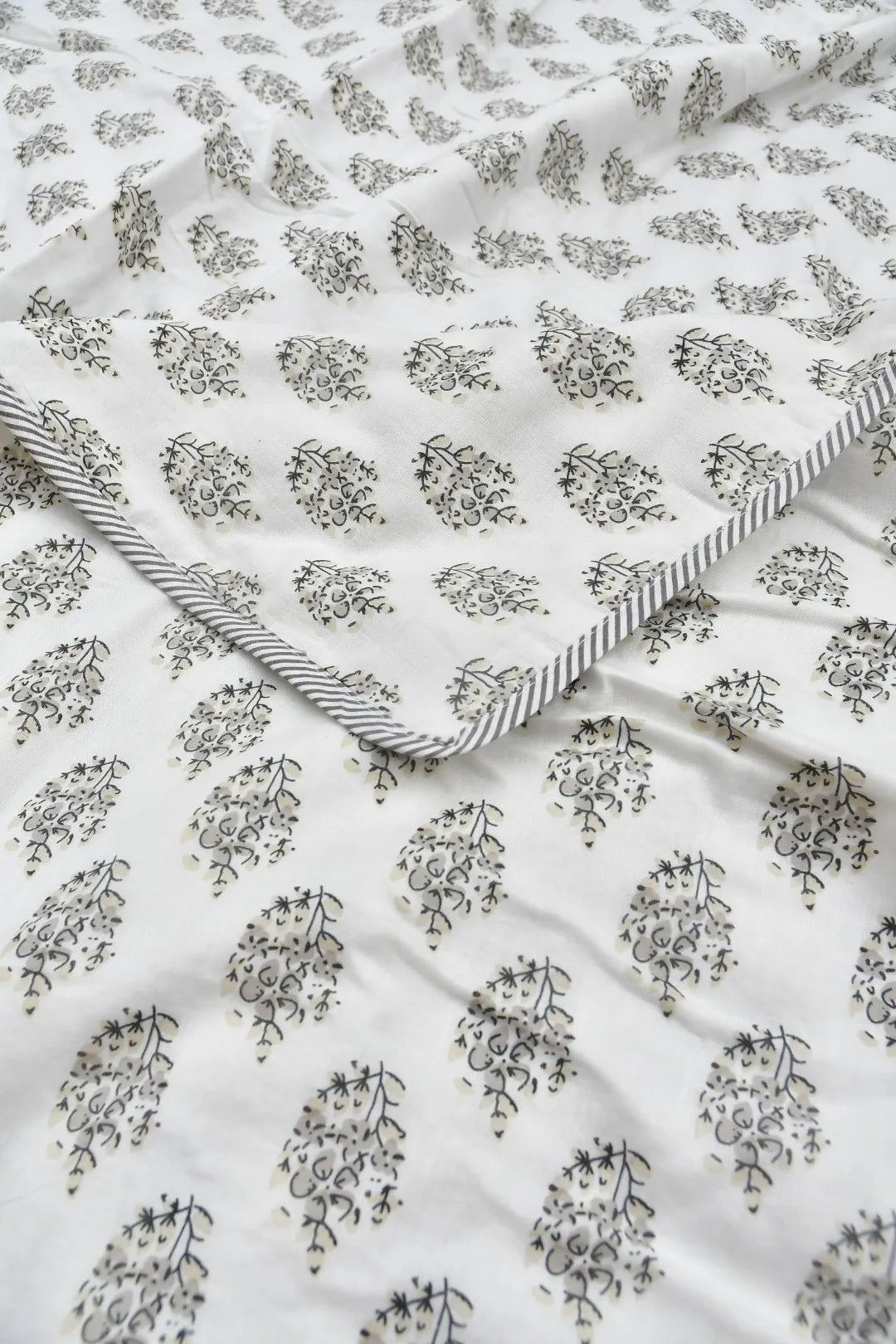 Floral patterned Dohar with a striped border on a white background