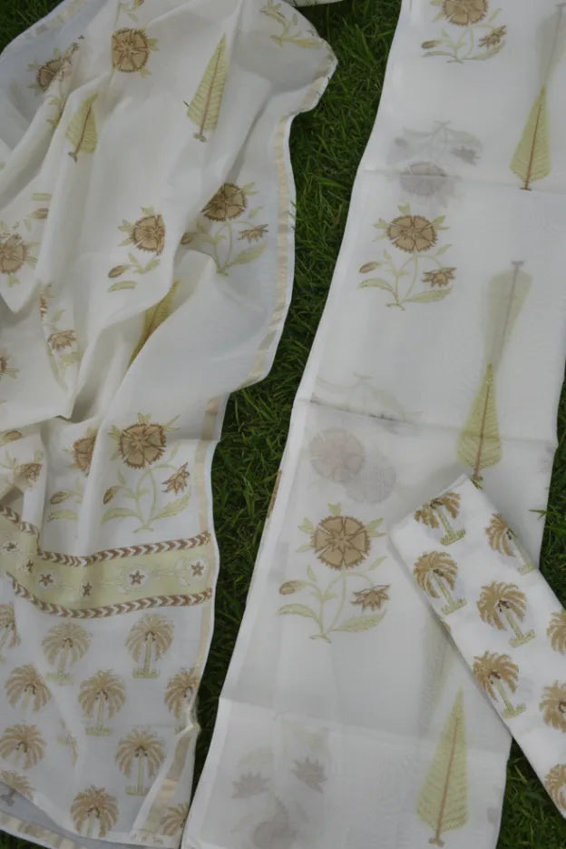 White fabric with floral patterns on a grassy background