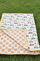 Baby blanket with car pattern on grass